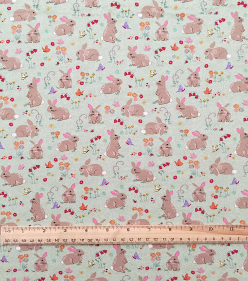 Bunnies on Green Interlock Knit Fabric - Image 2